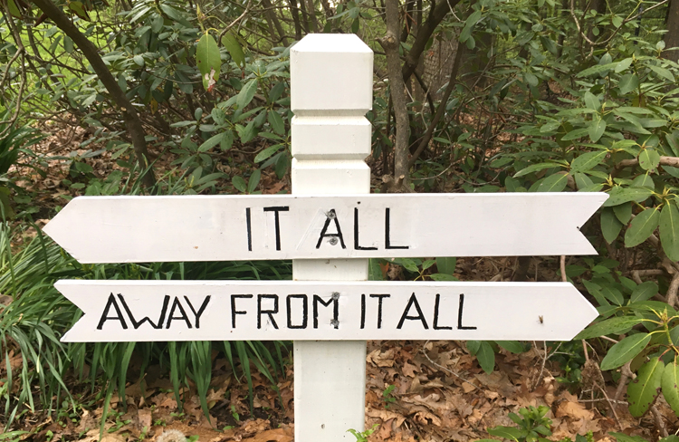 One sign points to the garden, the other to the road. Which one points which direction at L.G. (Spike) Walters' Butler garden?