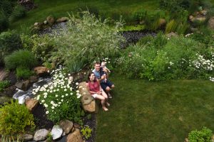 Scott and Catie Walsh of Sewickley Hills hold their seven month-old daughter Amara in the water garden that's part of the Wexford Pond Tour. The water garden is like a retreat for the young family.
