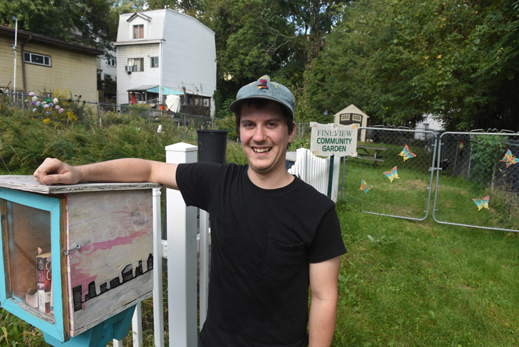 Dan Tomcik poses in front of the Fineview Community Garden.