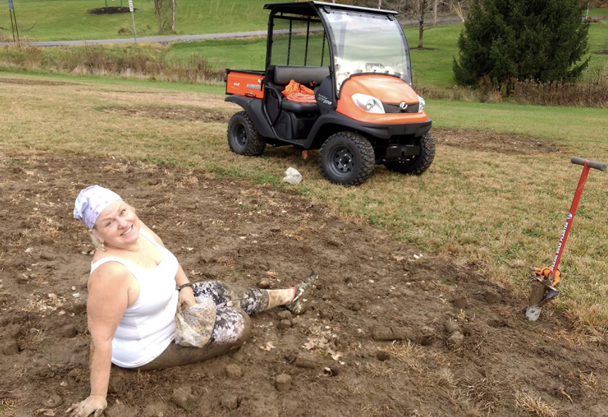 Emily Milich-Franusich is seen here planting daffodils right after knee replacement surgery. Her husband Michael Franusich helped her plant a two acre field with daffodils in memory of Emily's sister Marsha Milich.